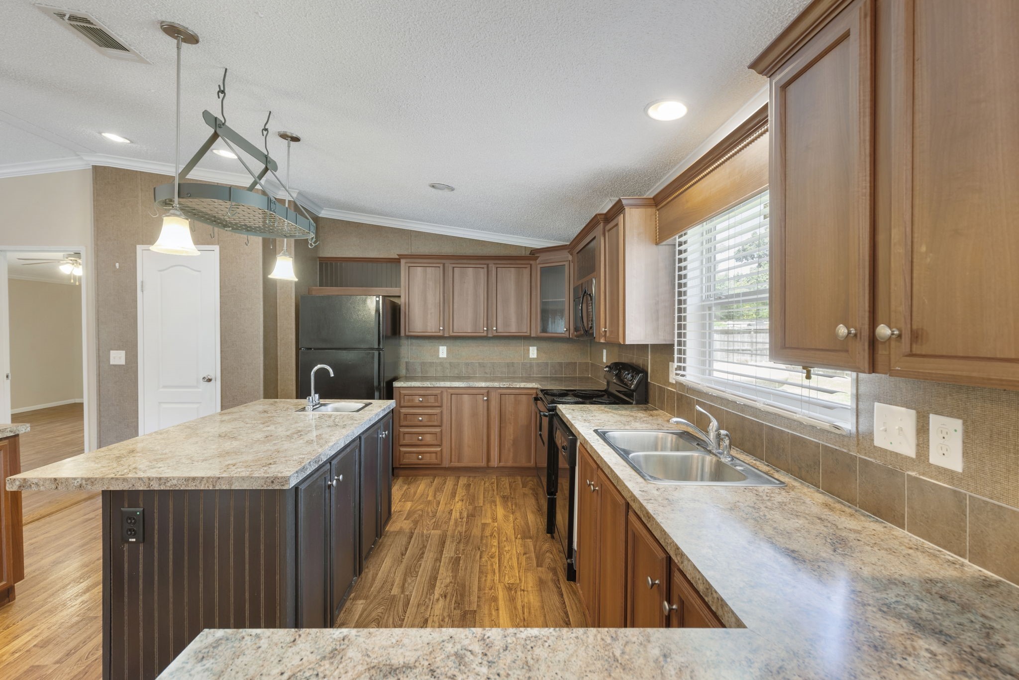 25330 Settlers Mill Road Magnolia, TX 77355 - Photo 14 of 21 a kitchen with a stove a sink a center island and a window