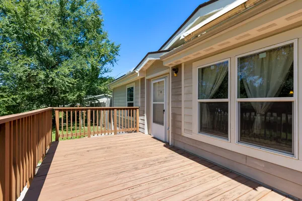 a balcony with wooden floor and fence