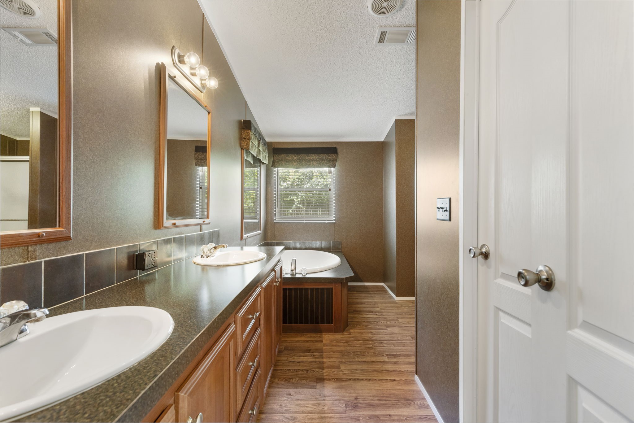 25330 Settlers Mill Road Magnolia, TX 77355 - Photo 7 of 21 a spacious bathroom with a granite countertop double vanity sink a mirror and a shower