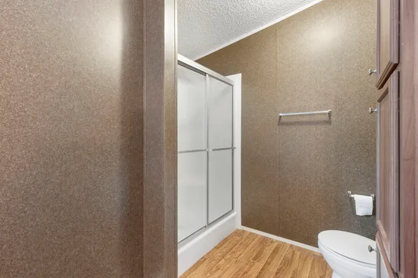 a bathroom with a toilet and a shower