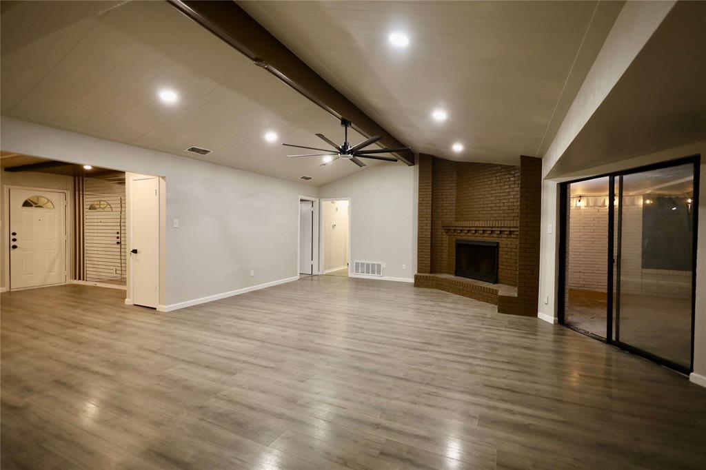 905 Pine Tree Lane DeSoto, TX 75115 - Photo 4 of 11 Unfurnished living room featuring ceiling fan, wood finished floors, a brick fireplace, and recessed lighting