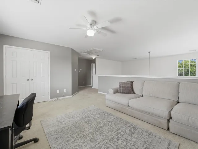 a living room with furniture and a chair