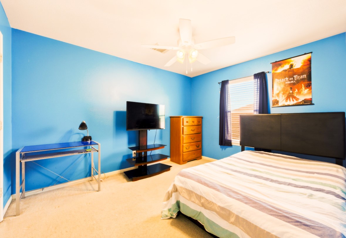 21631 Falvel Misty Drive Spring, TX 77388 - Photo 20 of 29 a bedroom with a bed and a flat screen tv