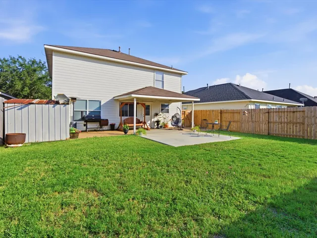 a view of a house with a yard and sitting area