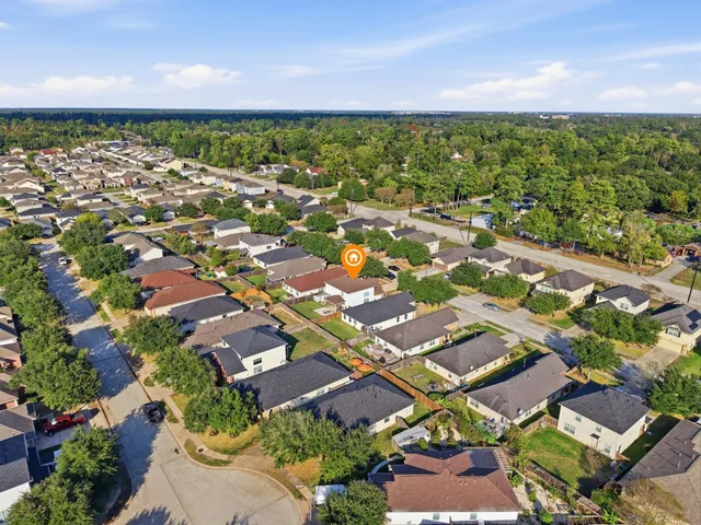 an aerial view of residential houses with outdoor space
