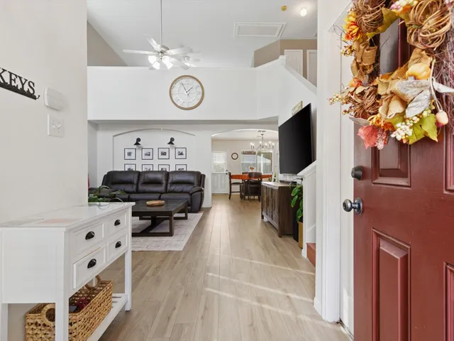a living room with furniture and a clock
