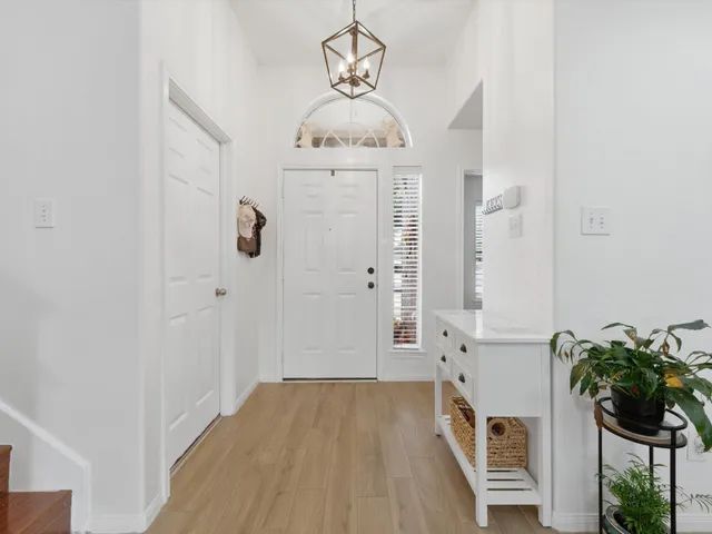 a view of an entryway with wooden floor
