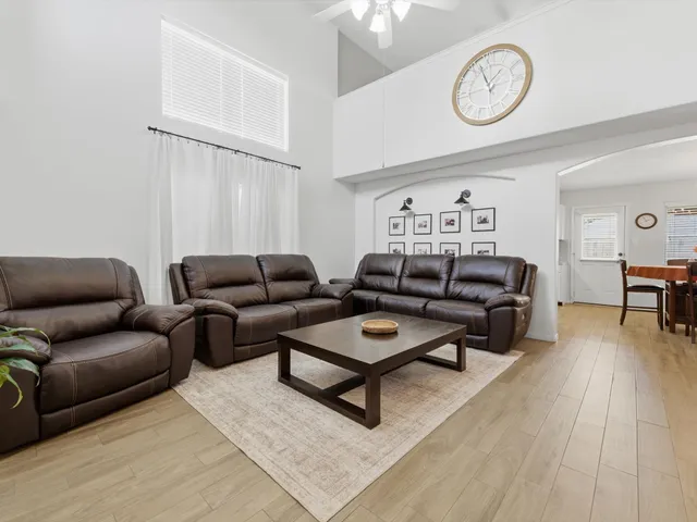 a living room with furniture a rug and a window