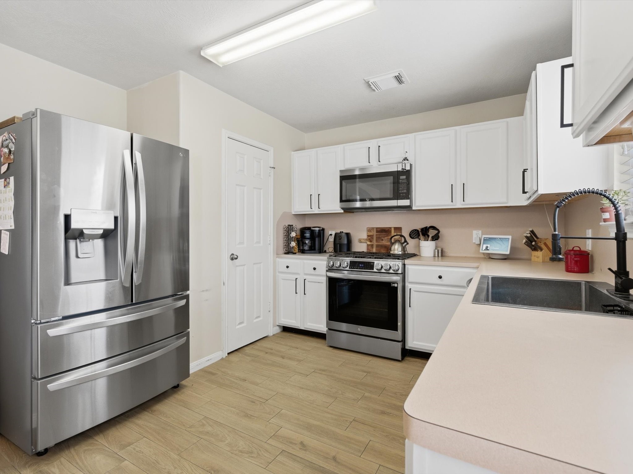 21631 Falvel Misty Drive Spring, TX 77388 - Photo 10 of 29 a kitchen with stainless steel appliances granite countertop a refrigerator stove and sink