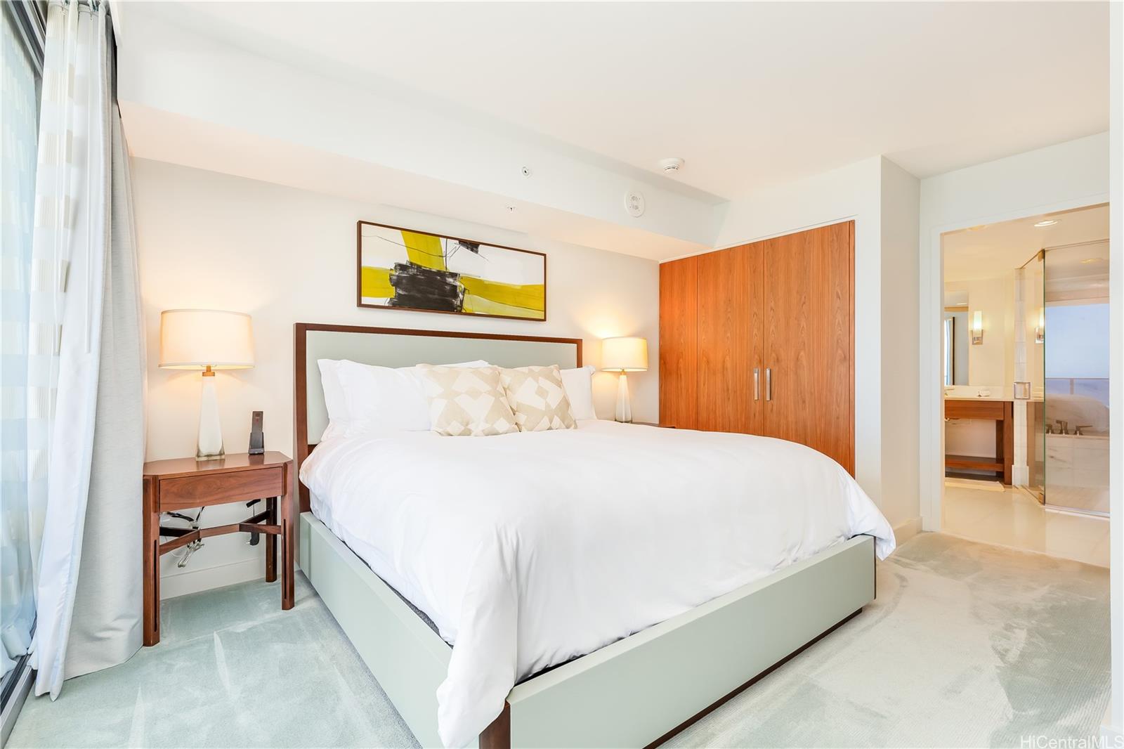 2139 Kūhiō Avenue, Unit 34 Honolulu, HI 96815 - Photo 11 of 25 a bedroom with a bed and a painting on the wall