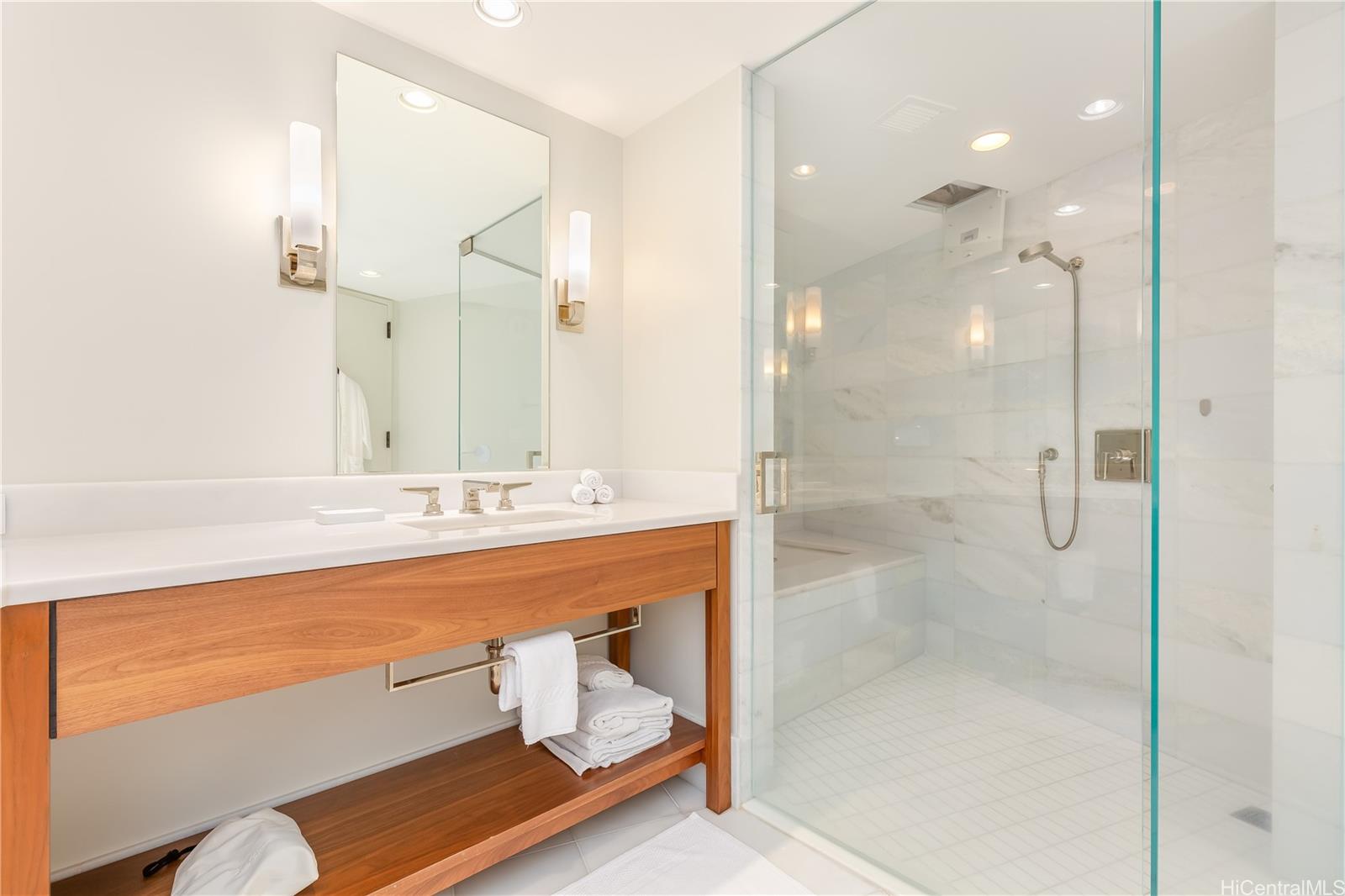 2139 Kūhiō Avenue, Unit 34 Honolulu, HI 96815 - Photo 12 of 25 a bathroom with a bathtub and a shower