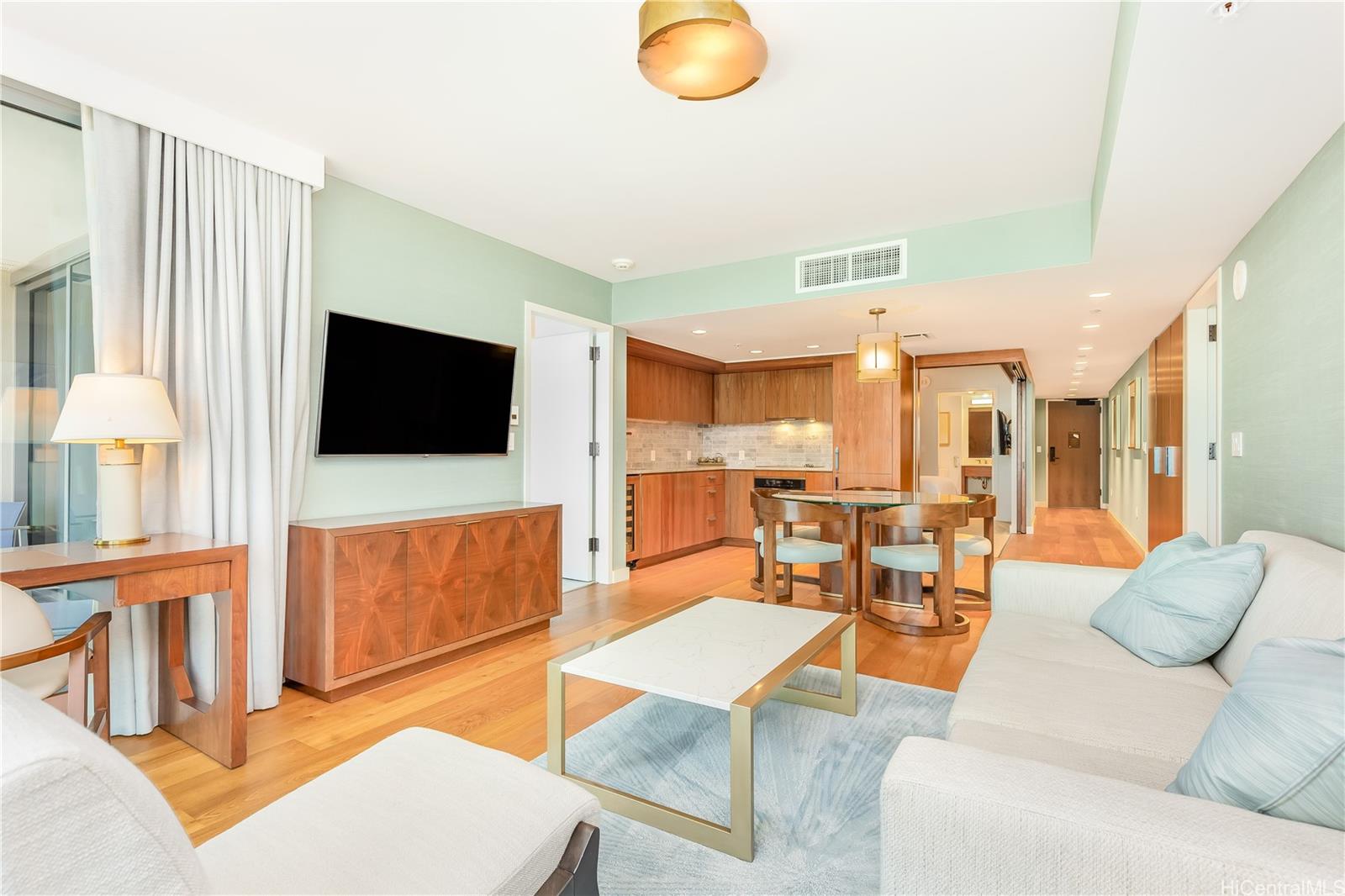 2139 Kūhiō Avenue, Unit 34 Honolulu, HI 96815 - Photo 6 of 25 a living room with furniture and a flat screen tv