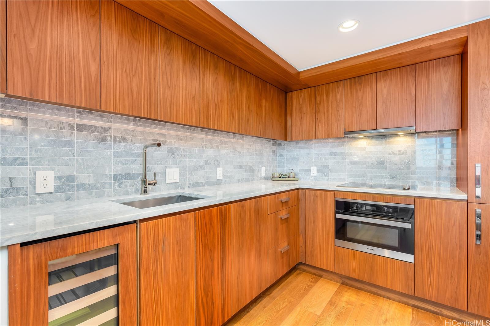 2139 Kūhiō Avenue, Unit 34 Honolulu, HI 96815 - Photo 9 of 25 a kitchen with granite countertop wood cabinets stainless steel appliances and sink