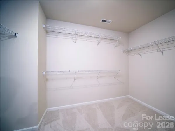 a bathroom with a double vanity sink toilet and a mirror