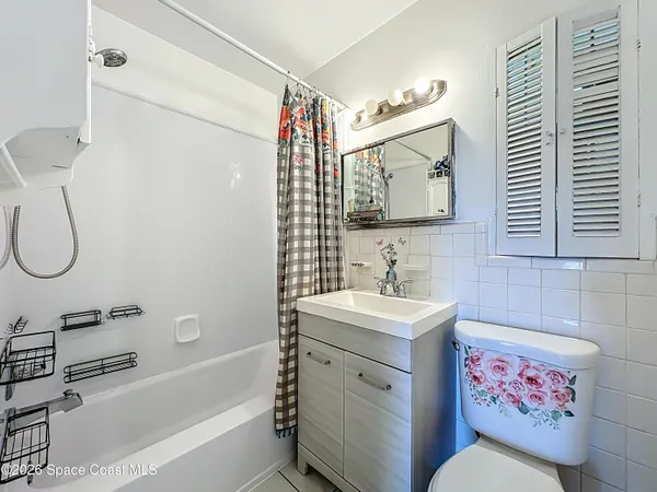 a bathroom with a sink vanity mirror and a bathtub