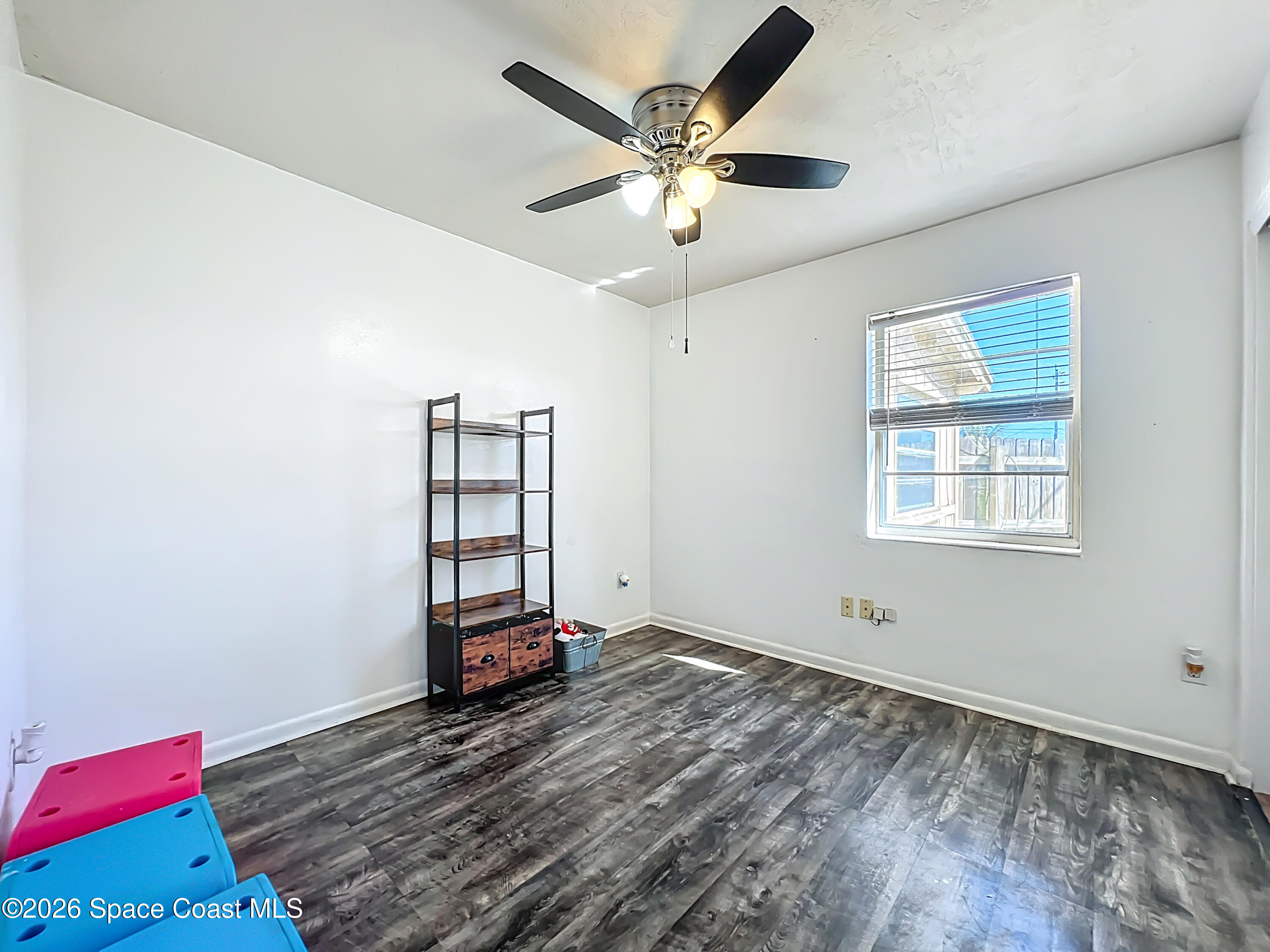 1090 Bianca Drive Northeast Palm Bay, FL 32905 - Photo 14 of 30 wooden floor in an empty room with a window