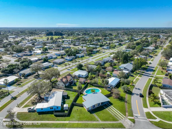 an aerial view of a house with a swimming pool