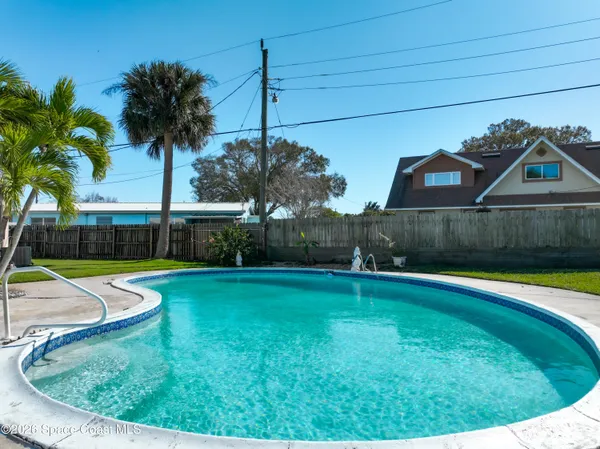a view of a backyard with swimming pool
