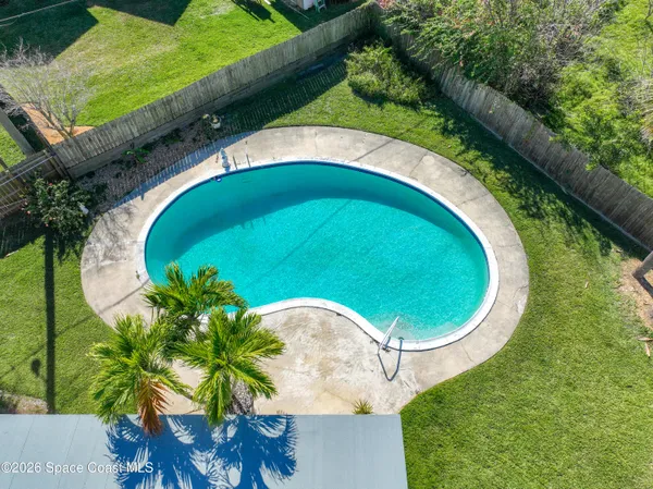 an aerial view of a house with a swimming pool