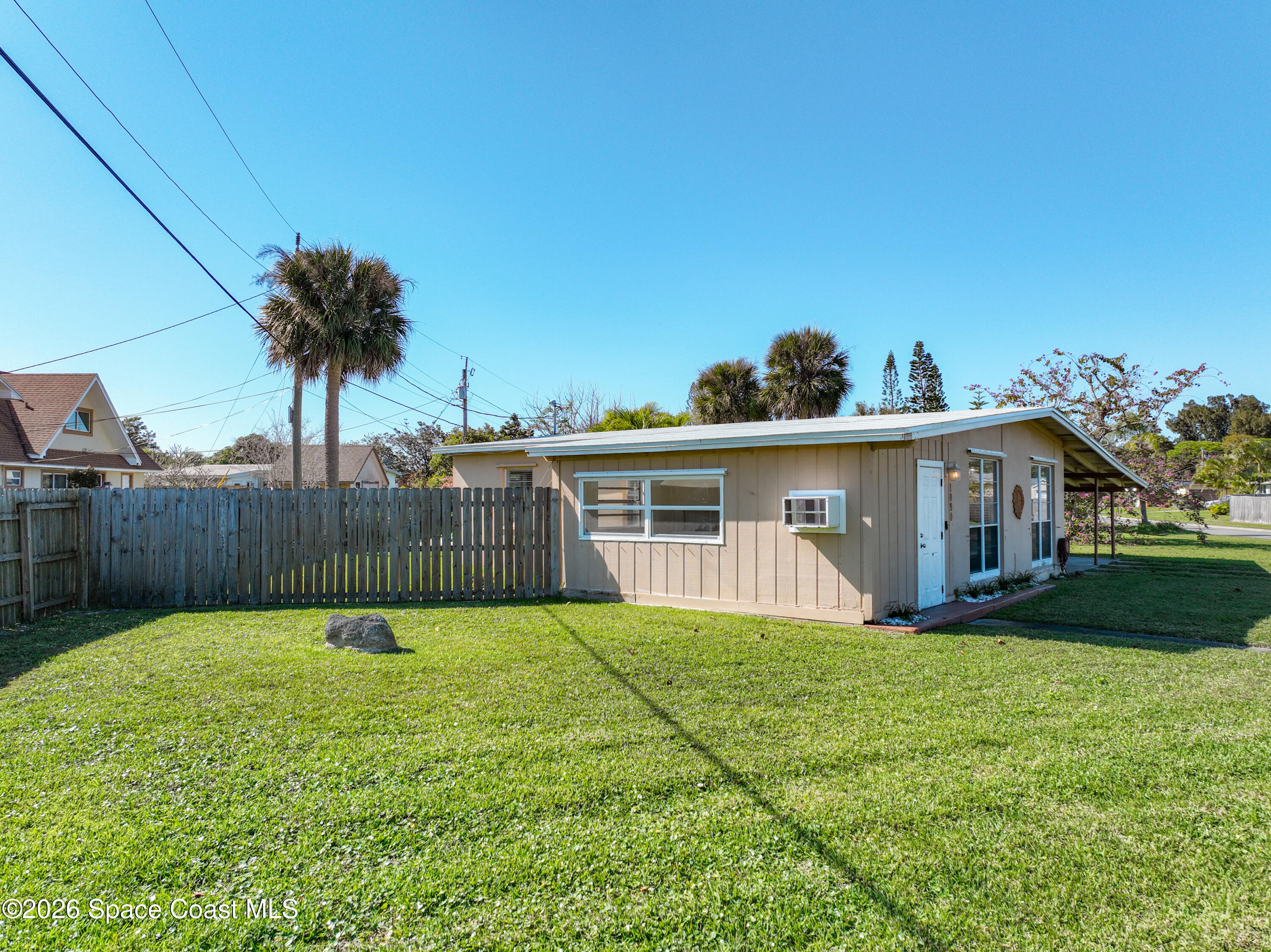 1090 Bianca Drive Northeast Palm Bay, FL 32905 - Photo 4 of 30 a view of a yard in front of a house with a yard