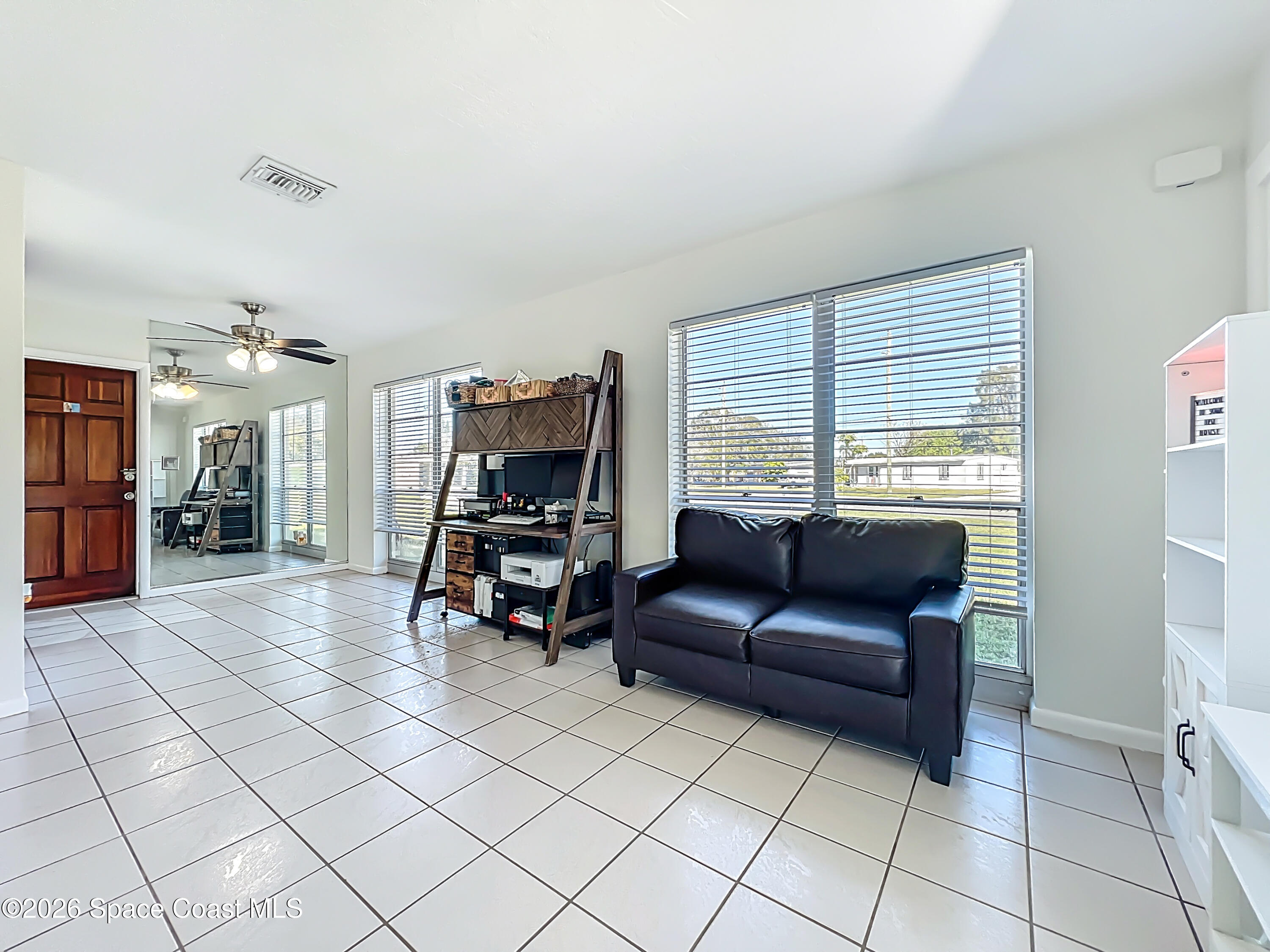 1090 Bianca Drive Northeast Palm Bay, FL 32905 - Photo 9 of 30 a living room with furniture and a flat screen tv