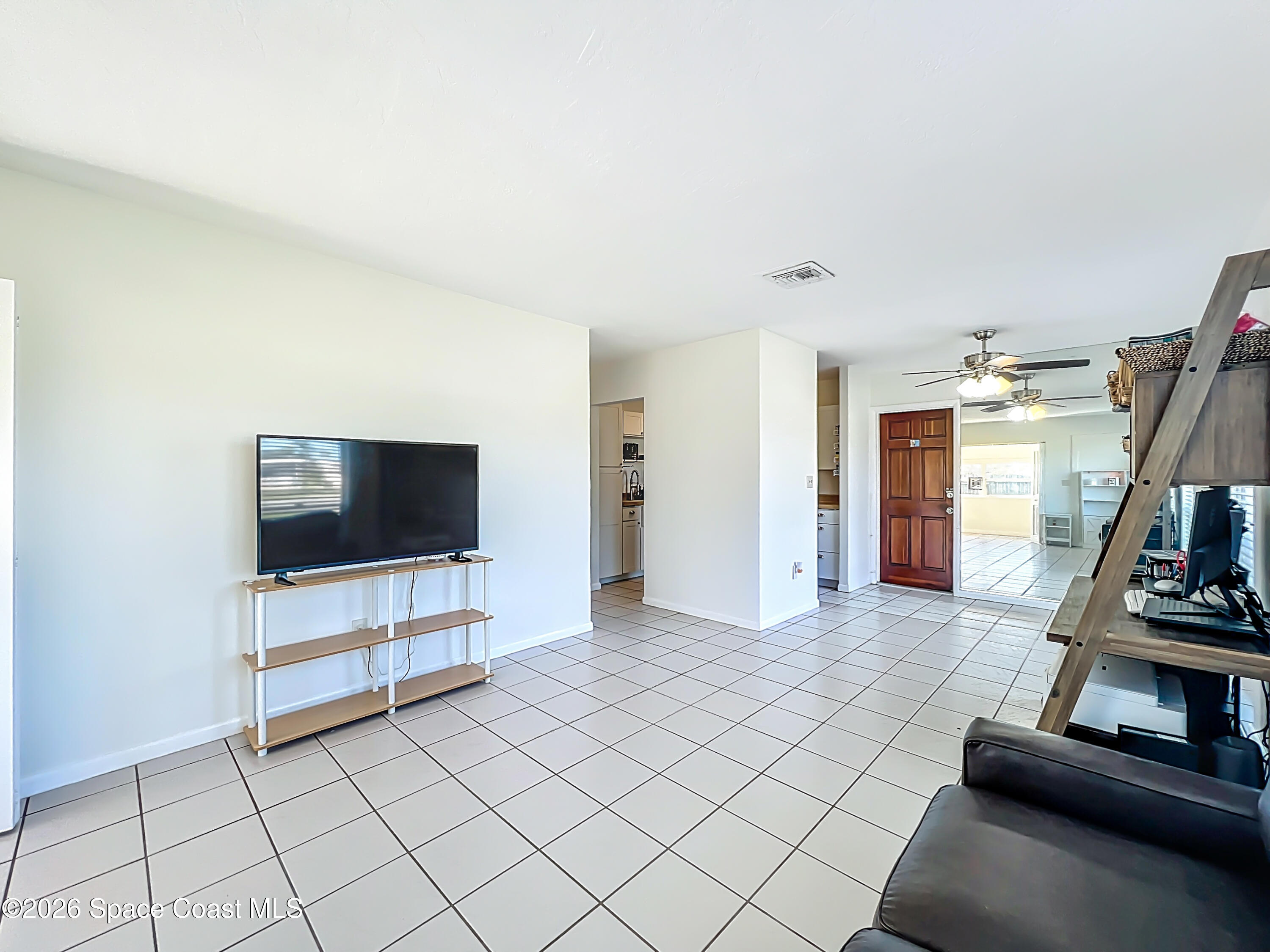 1090 Bianca Drive Northeast Palm Bay, FL 32905 - Photo 10 of 30 a living room with furniture and a flat screen tv