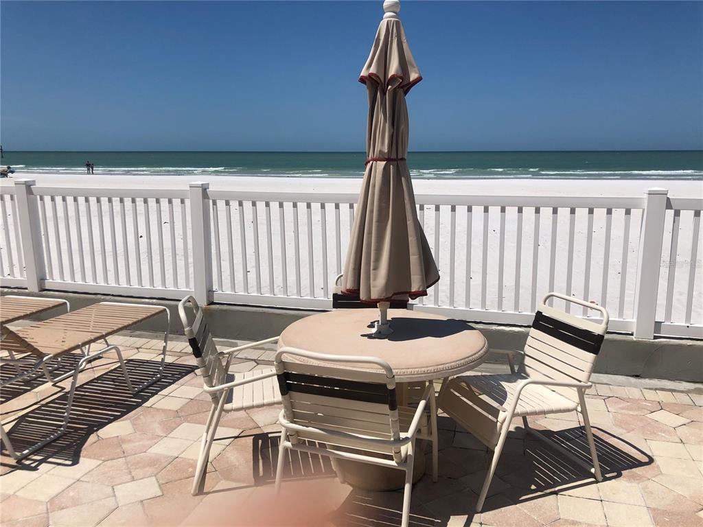 17580 Gulf Boulevard, Unit 206 Redington Shores, FL 33708 - Photo 11 of 11 a table and chairs in a patio