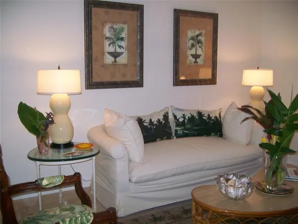 a living room with furniture and a potted plant