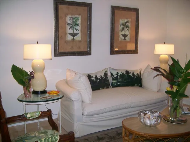 a living room with furniture and a potted plant