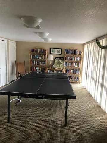 a living room with furniture pool table and window