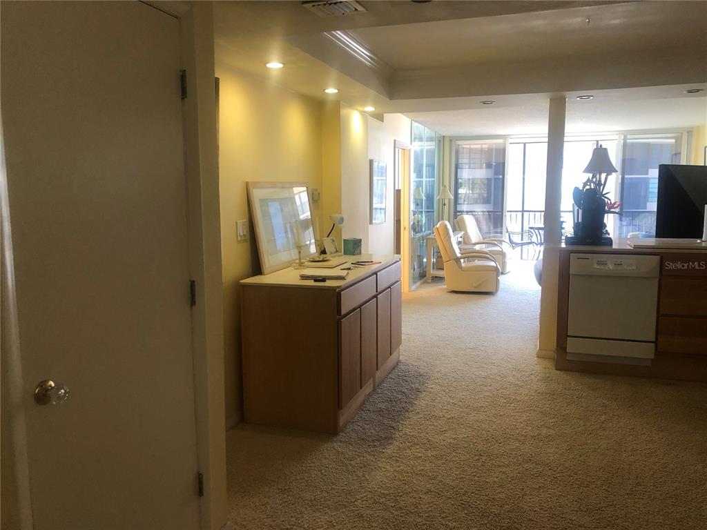 17580 Gulf Boulevard, Unit 206 Redington Shores, FL 33708 - Photo 8 of 11 a view of a room with kitchen island stainless steel appliances wooden floor and living room view