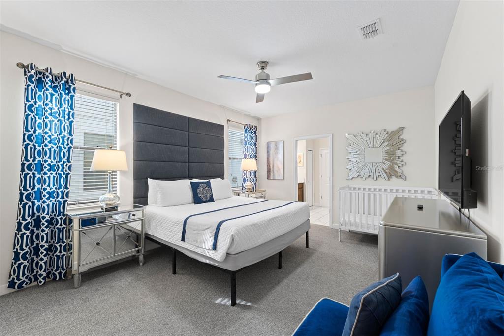 2933 Fable Street Kissimmee, FL 34746 - Photo 15 of 53 a bed room with a bed window and a flat screen tv