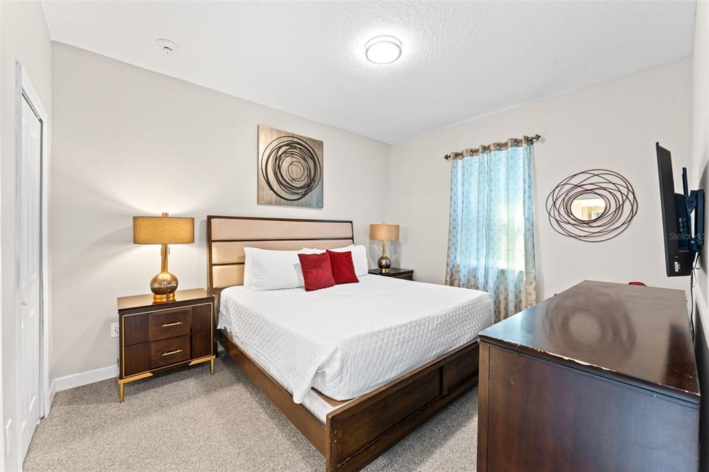 2933 Fable Street Kissimmee, FL 34746 - Photo 20 of 53 a bedroom with a bed and a chandelier