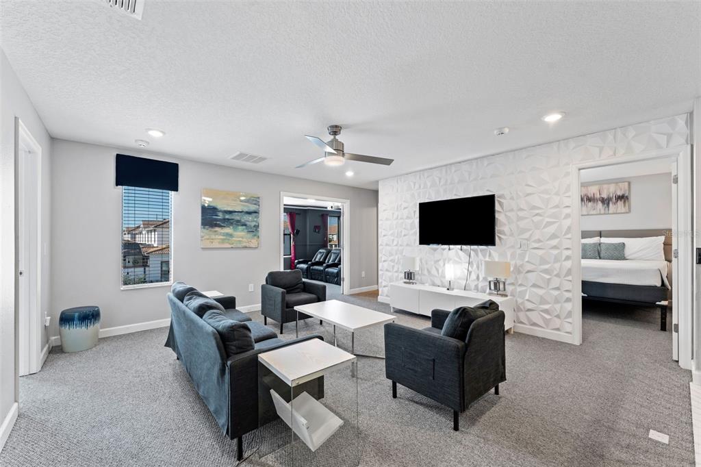 2933 Fable Street Kissimmee, FL 34746 - Photo 27 of 53 a living room with furniture wooden floor and a flat screen tv