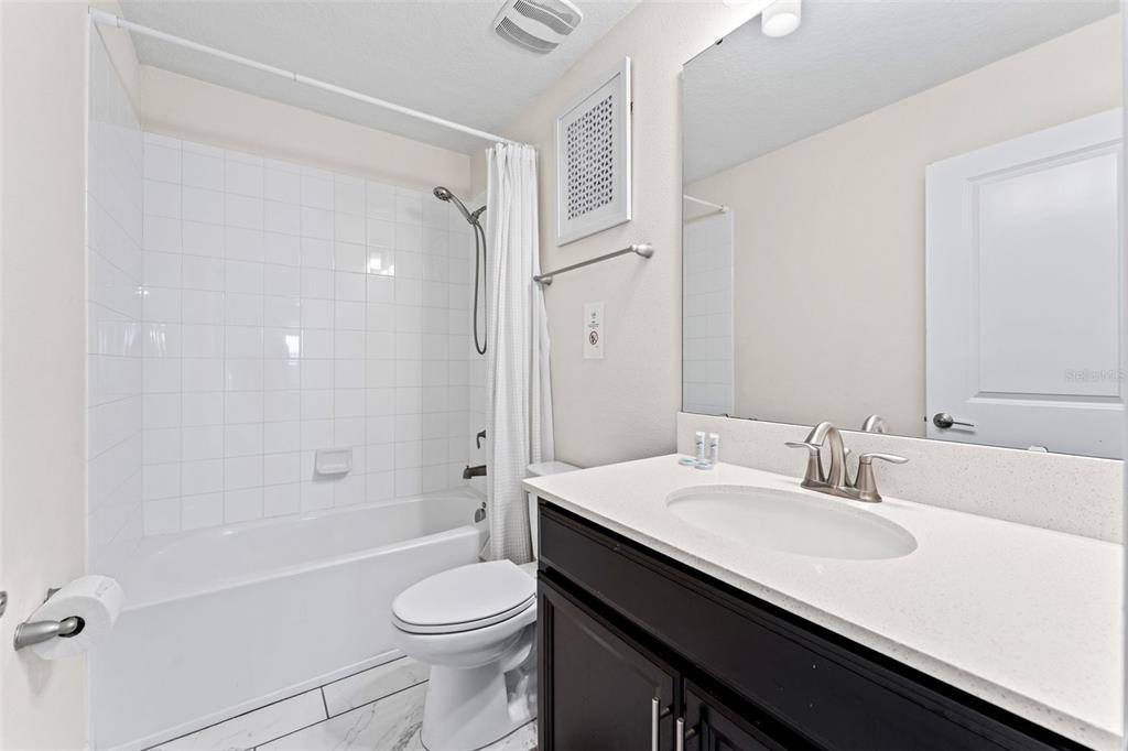 2933 Fable Street Kissimmee, FL 34746 - Photo 30 of 53 a bathroom with a sink a toilet and shower