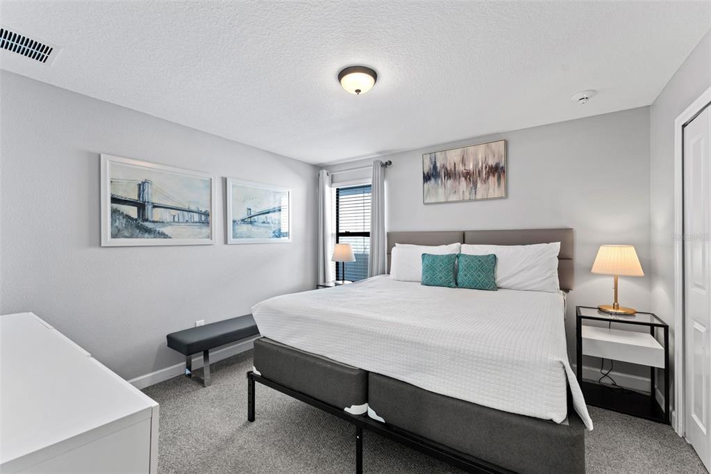 2933 Fable Street Kissimmee, FL 34746 - Photo 33 of 53 a bedroom with a bed and a lamp on table