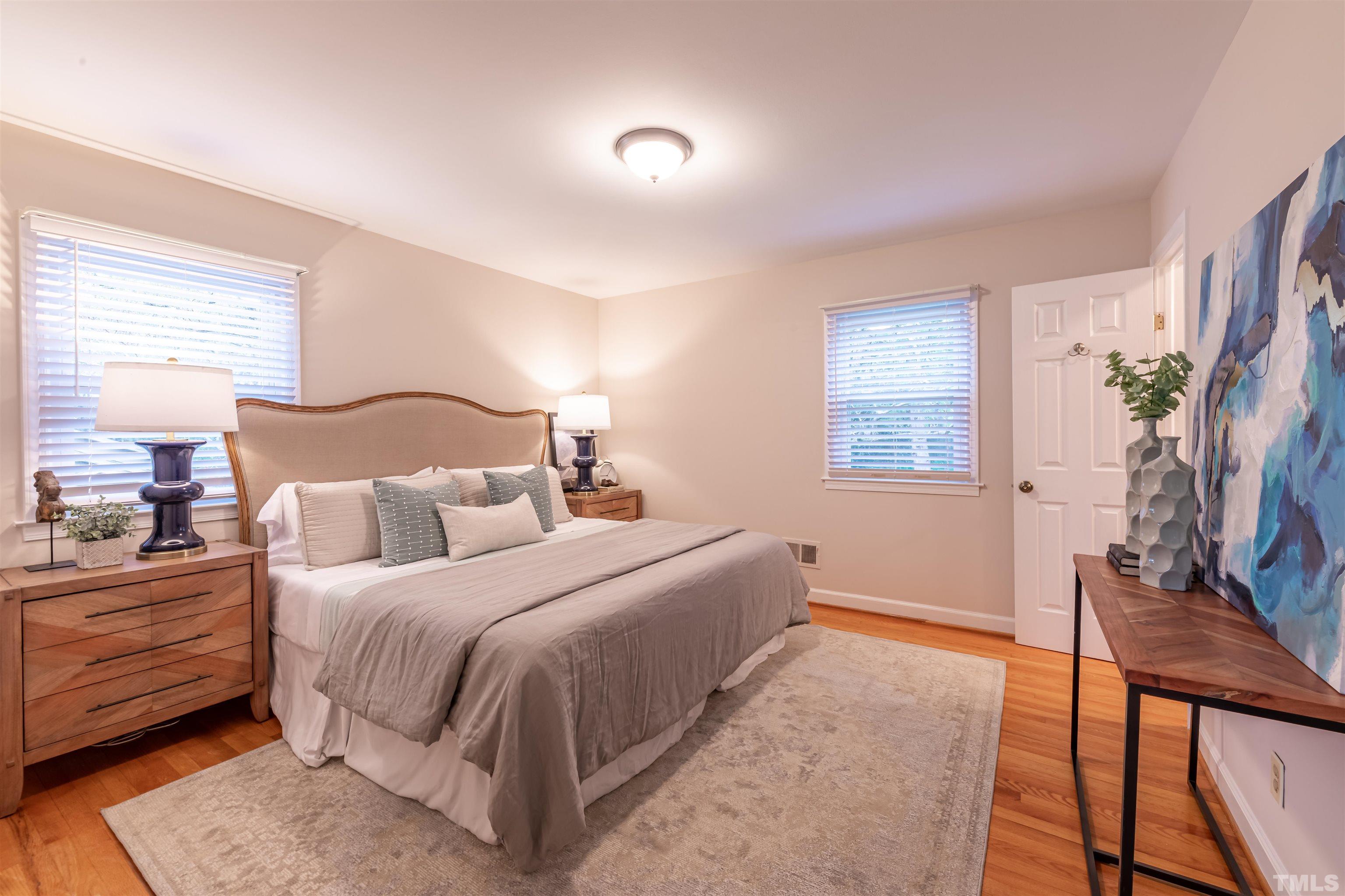 3101 Sherry Drive Raleigh, NC 27604 - Photo 12 of 28 a bedroom with a bed and wooden floor
