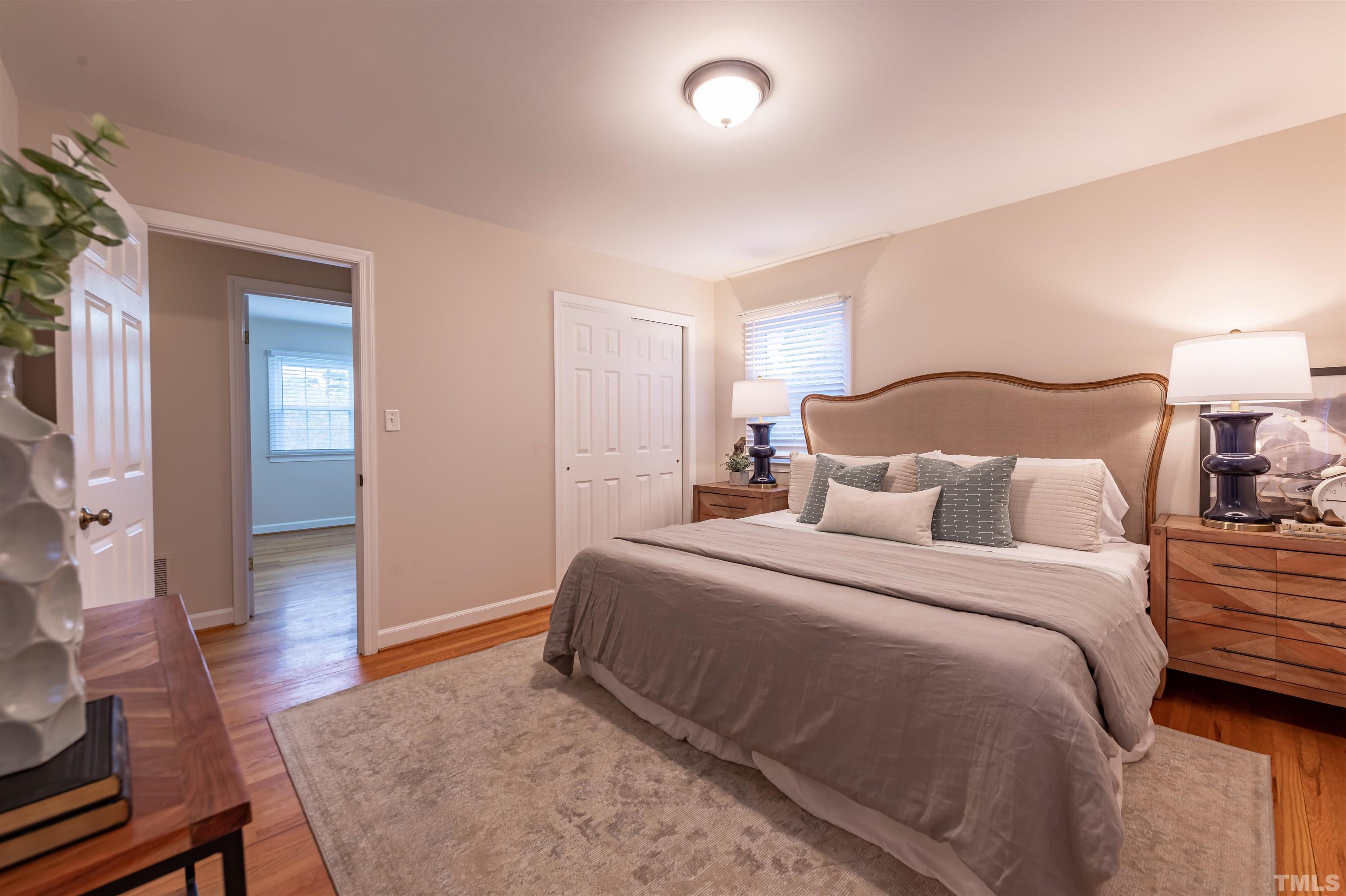 3101 Sherry Drive Raleigh, NC 27604 - Photo 13 of 28 a spacious bedroom with a bed and wooden floor