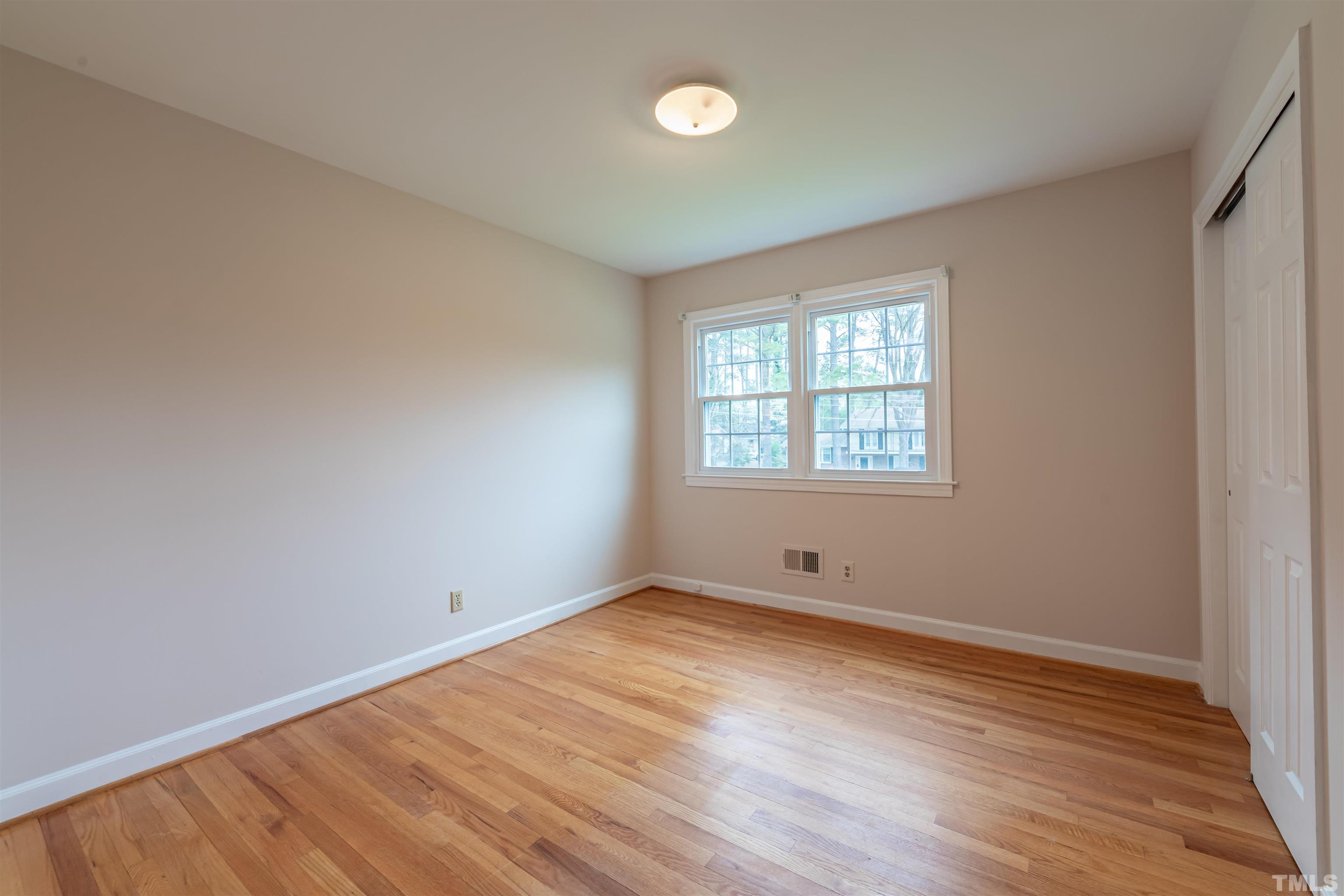 3101 Sherry Drive Raleigh, NC 27604 - Photo 15 of 28 an empty room with wooden floor and windows