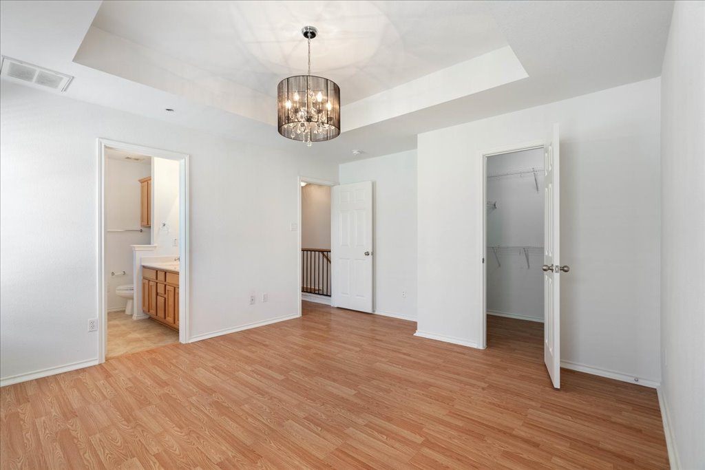 14815 Avery Ranch Boulevard, Unit 302 Austin, TX 78717 - Photo 16 of 28 a view of an empty room with wooden floor and a window
