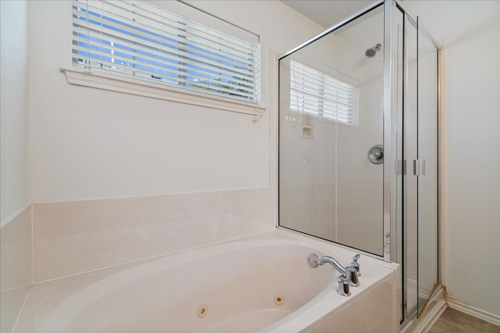 14815 Avery Ranch Boulevard, Unit 302 Austin, TX 78717 - Photo 18 of 28 a bathroom with a bathtub and a shower