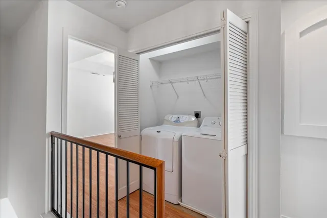 a view of a hallway with washer and dryer