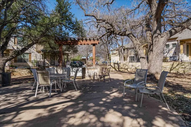 a view of a patio with table and chairs with wooden fence and plants