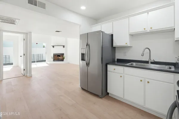 a kitchen with stainless steel appliances a refrigerator sink and cabinets