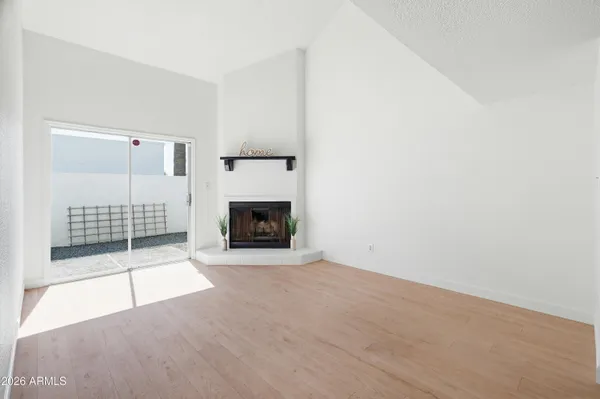 a view of an empty room with a fireplace
