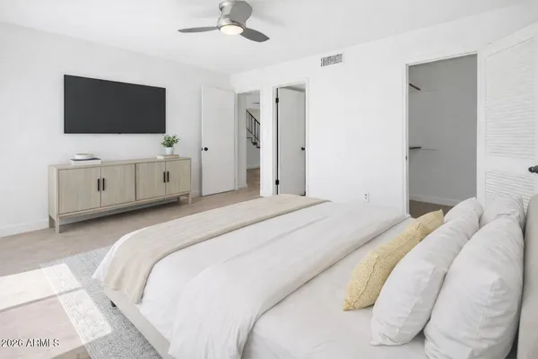 a bedroom with a bed and a flat screen tv