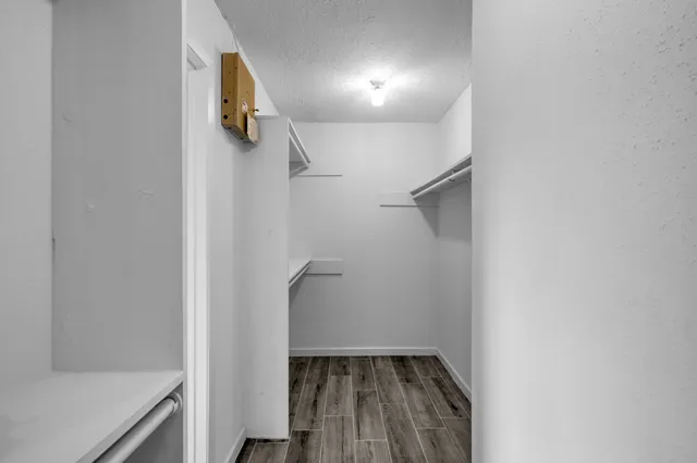 a view of walk in closet with empty racks