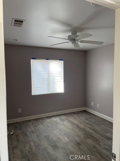 10645 East Ave R 12 Littlerock, CA 93543 - Photo 11 of 23 an empty room with wooden floor chandelier fan and windows