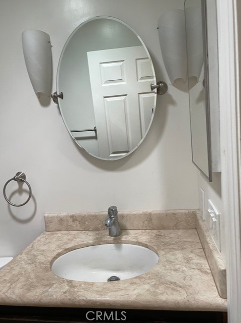 10645 East Ave R 12 Littlerock, CA 93543 - Photo 12 of 23 a bathroom with a granite countertop sink and a mirror