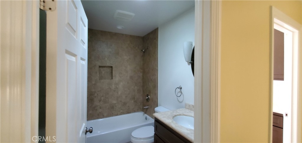 10645 East Ave R 12 Littlerock, CA 93543 - Photo 13 of 23 a bathroom with a granite countertop bathtub shower and toilet